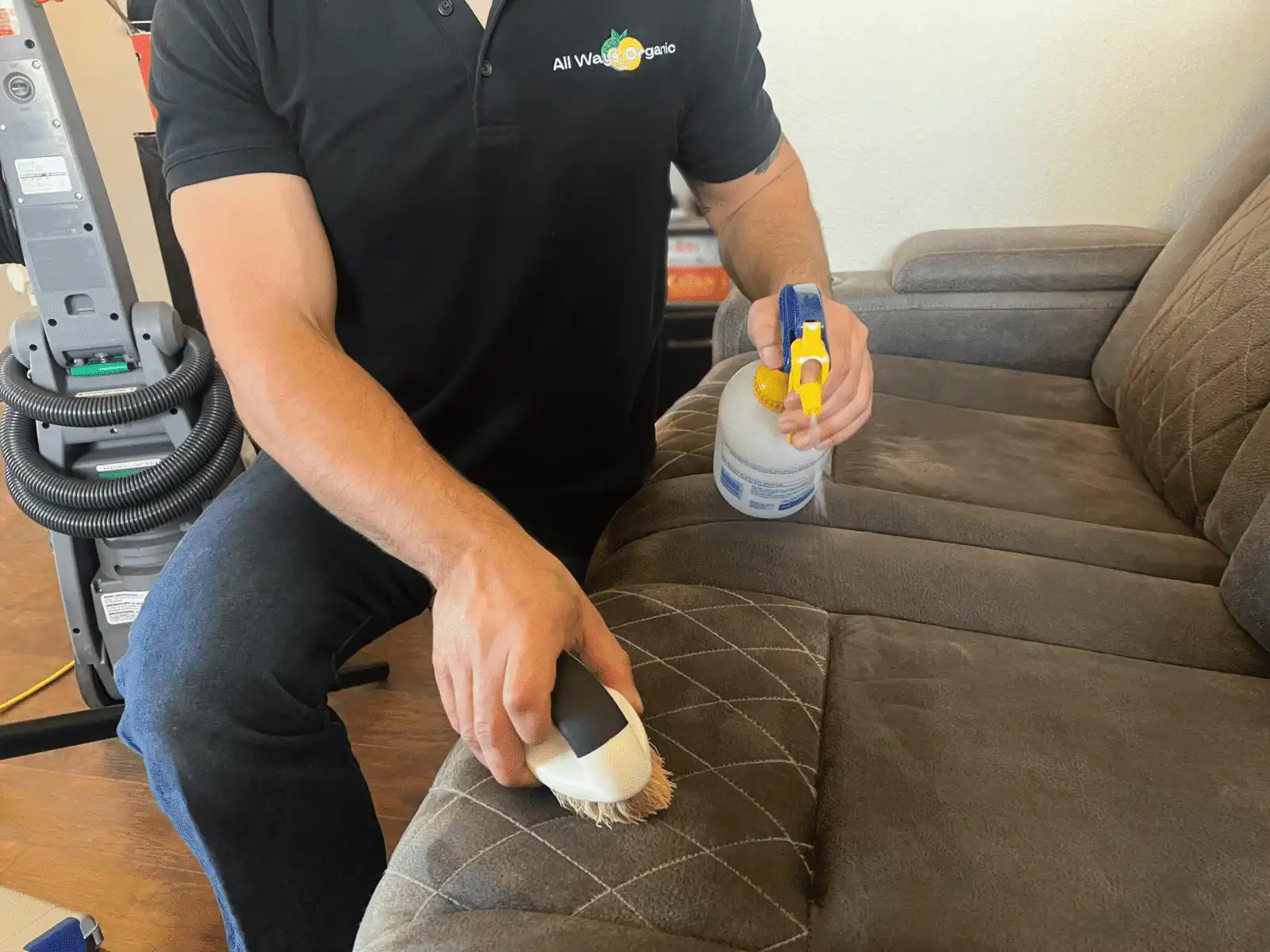 Kyle Stroud professionally cleaning couches in Phoenix home
