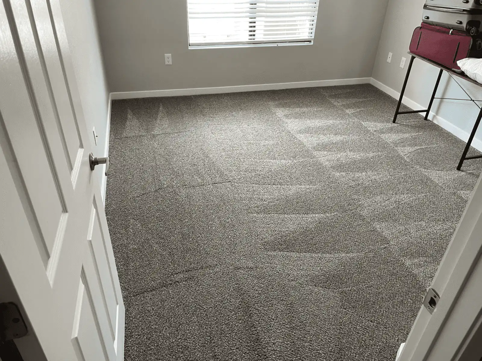 Before and after carpet cleaning in Surprise bedroom showing grayed carpet restored
