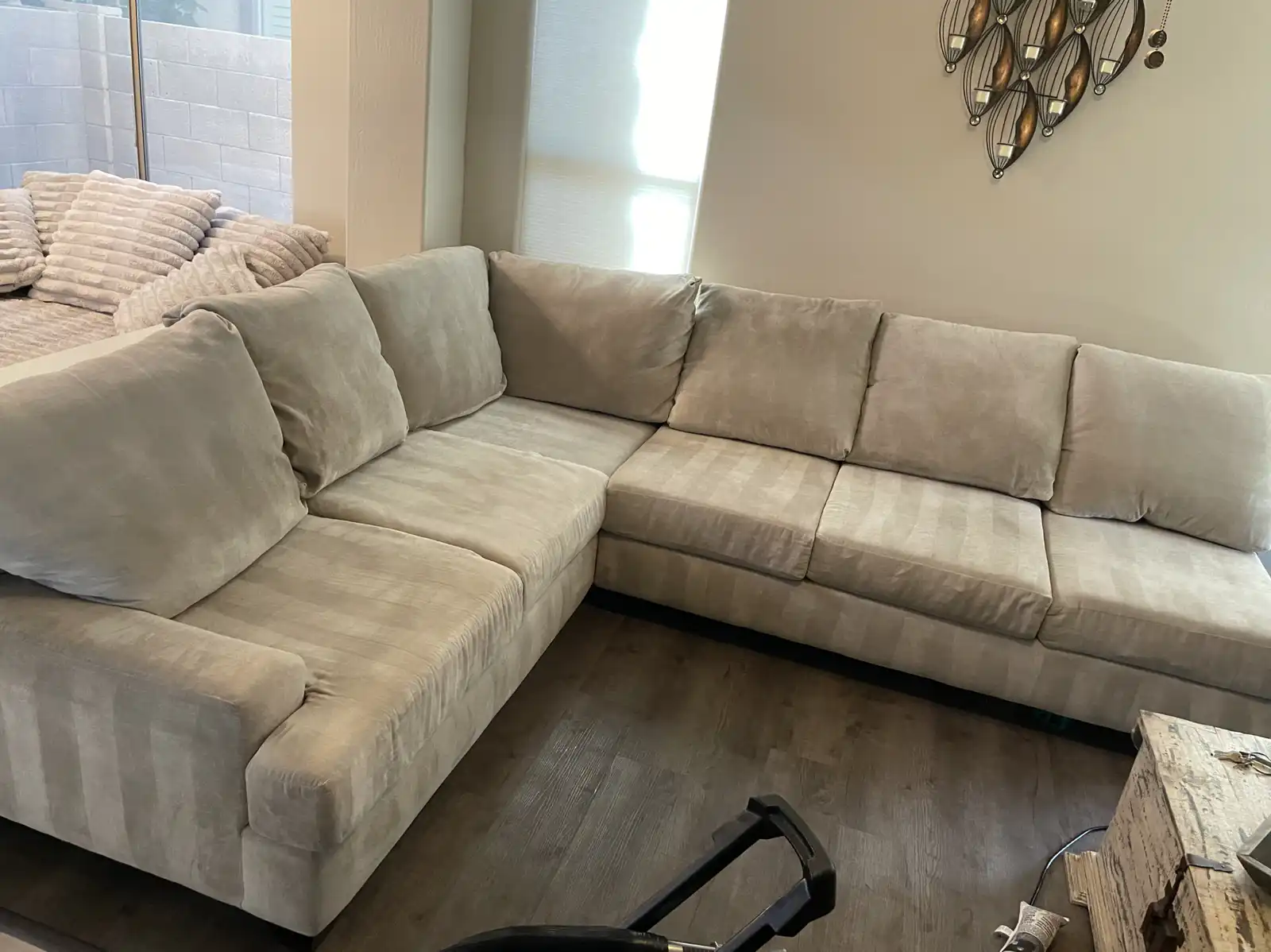 Before and after sectional couch cleaning in Avondale home showing oil stains removed from armrests