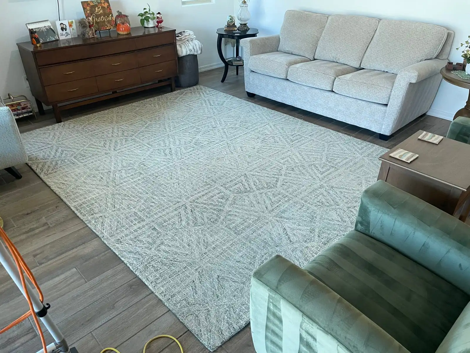 Before and after synthetic area rug cleaning in new Verrado home showing patterned area rug restored