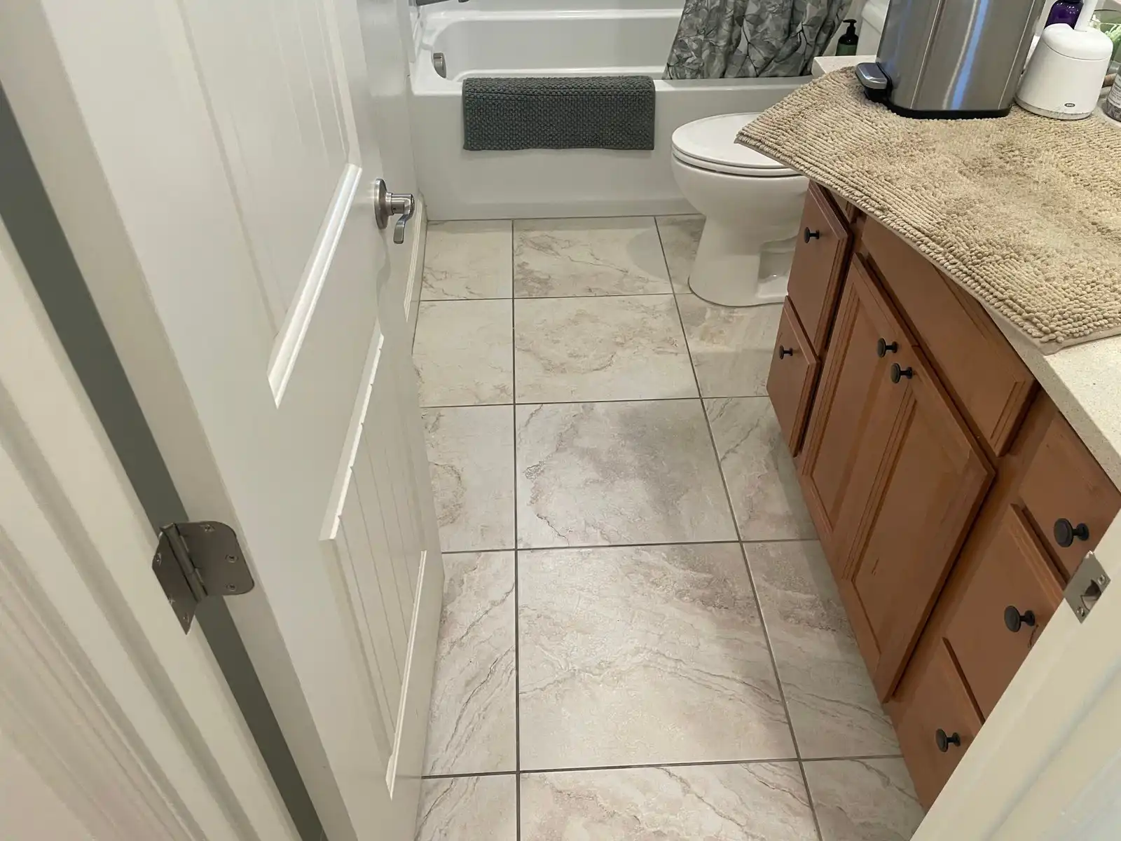 Before and after tile and grout cleaning in Peoria bathroom showing mop residue and darkened grout restored