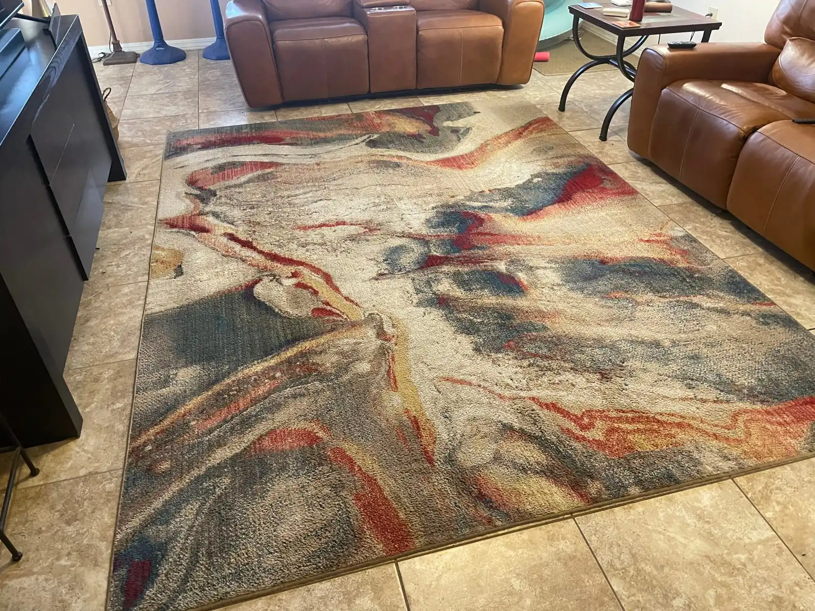 Before and after area rug cleaning in Goodyear home showing soil removed