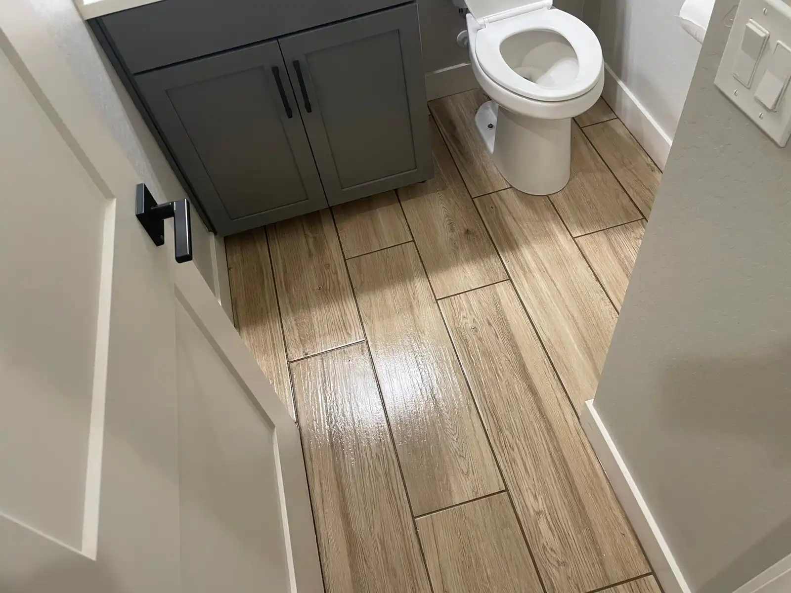 Before and after tile and grout cleaning in Litchfield Park bathroom showing residue removed